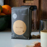 Sightglass's Owl's Howl Coffee bag on a table with a bowl of oranges and a jar in the background.